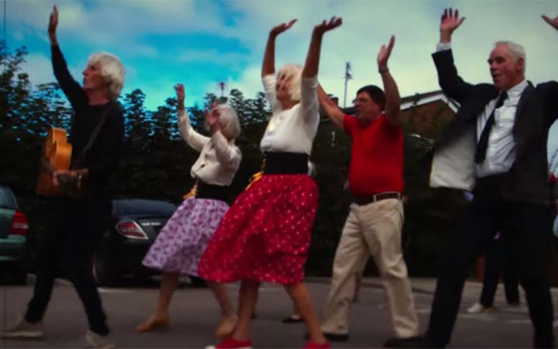 Chris West, left, leads local dancers in his music video