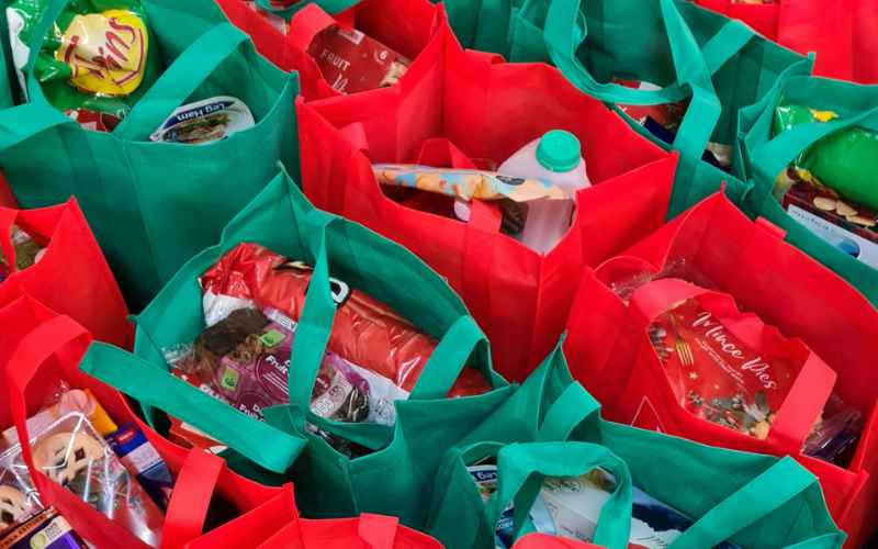 a group of red and green shopping bags for Brightlingsea Foodbank