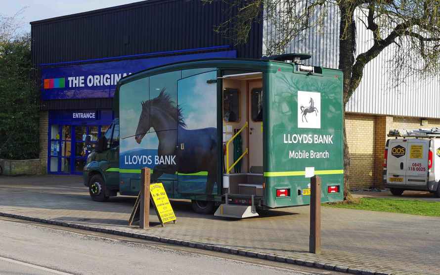 a green truck with a llyds bank horse on the side