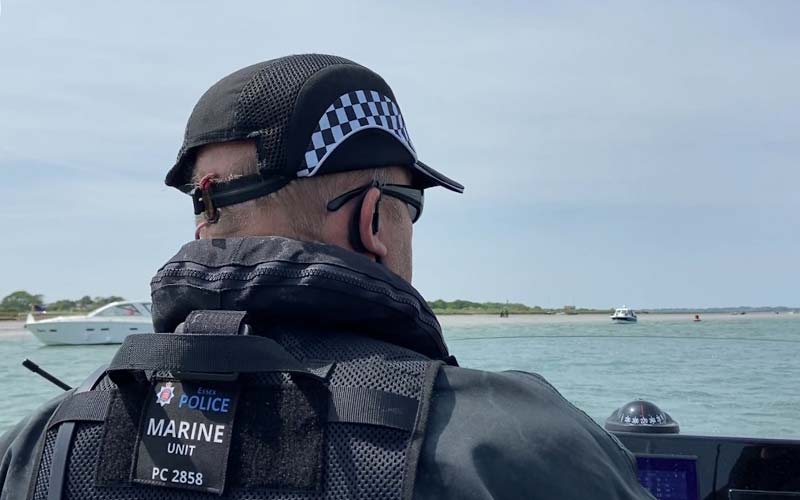 a marine police officer on patrol on a boat